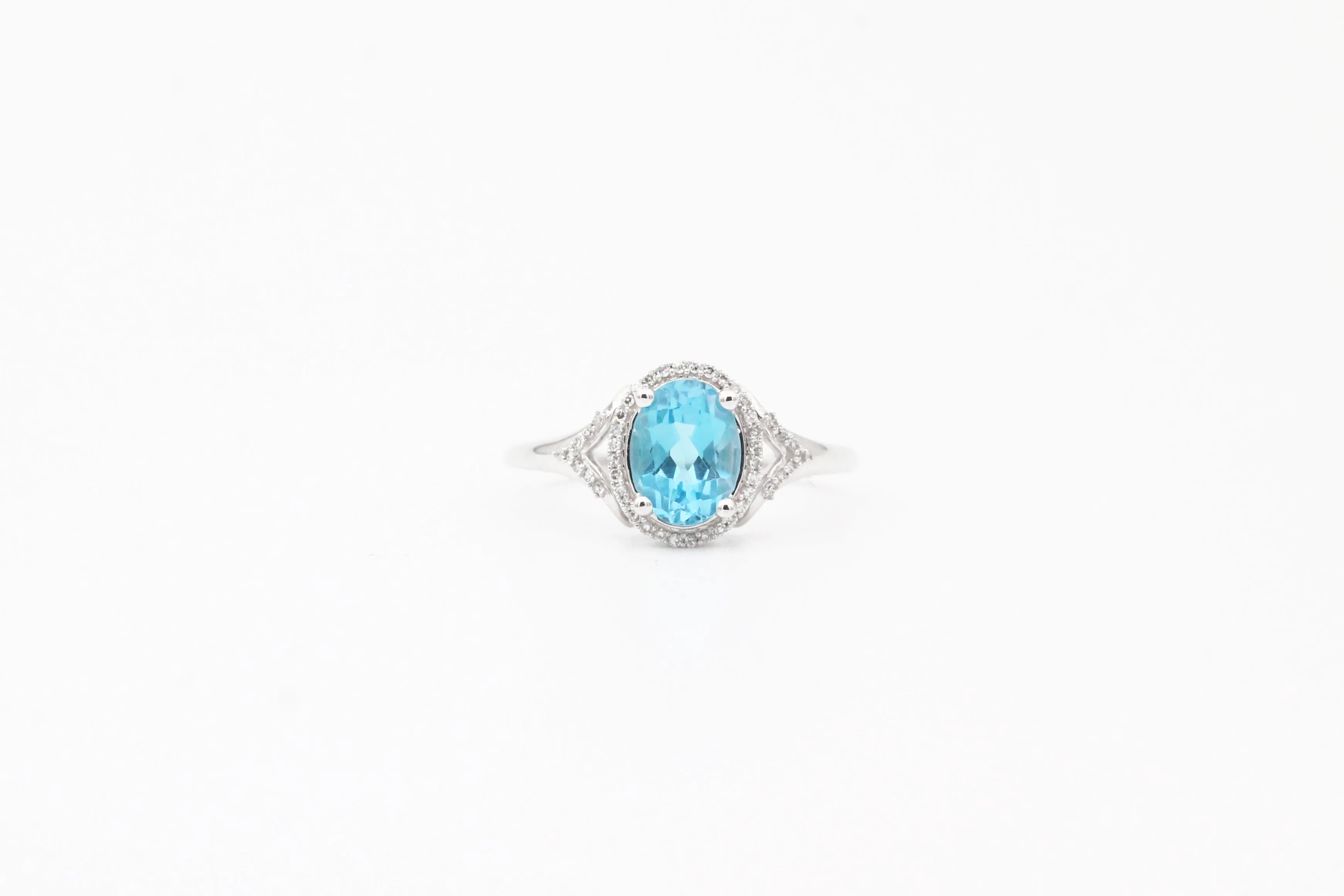 White Gold Oval Blue Topaz and Diamond Split Shank Halo Ring